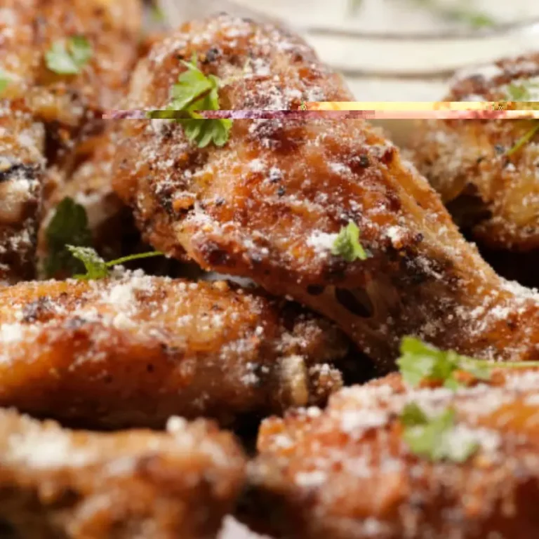 Close-up of crispy fried chicken wings garnished with fresh parsley